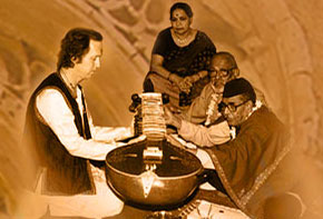 Mushtaq Ali Khan places the surbahar into my hands, the traditional method of introducing the student to the instrument before actual training is begun. D.T. Joshi and Ustadji's wife witnesses the occasion. 